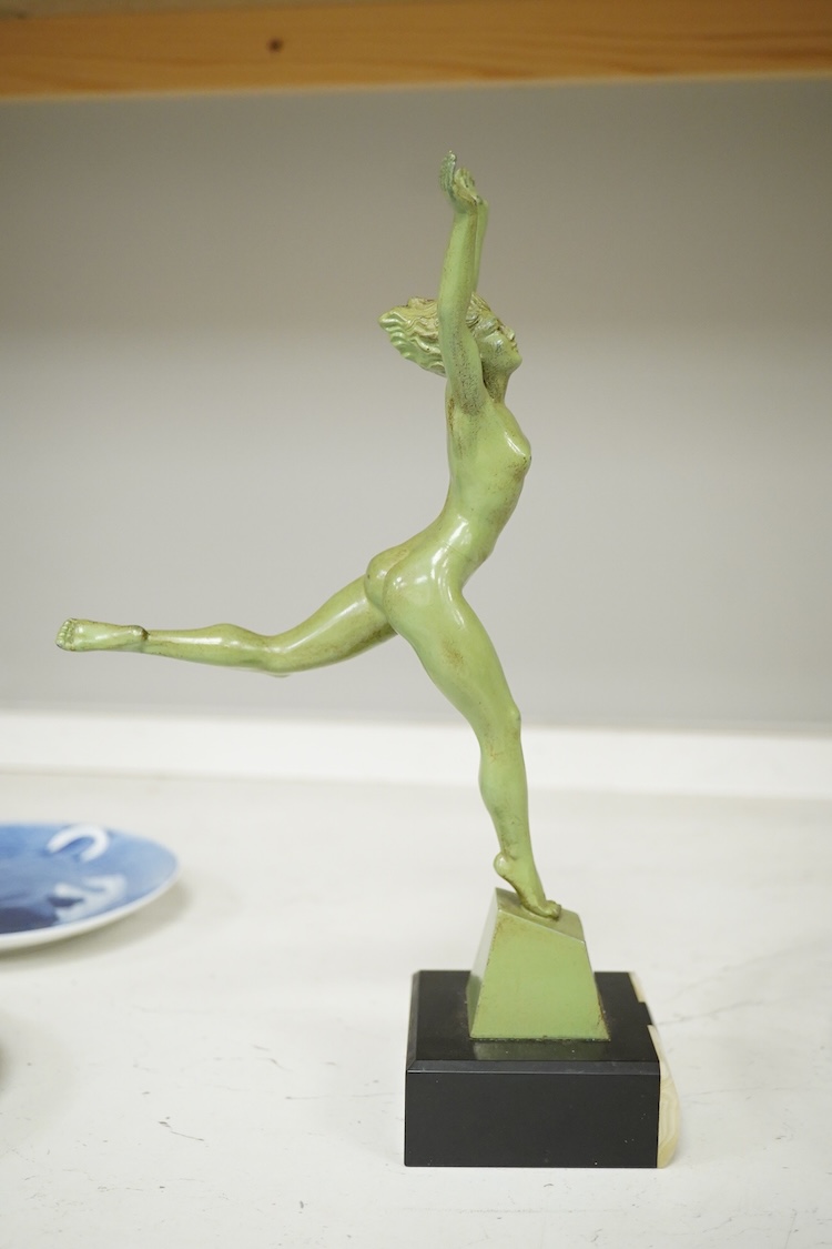 An Art Deco patinated spelter figurine of a nude dancer raised on black and green onyx base, 29cm high